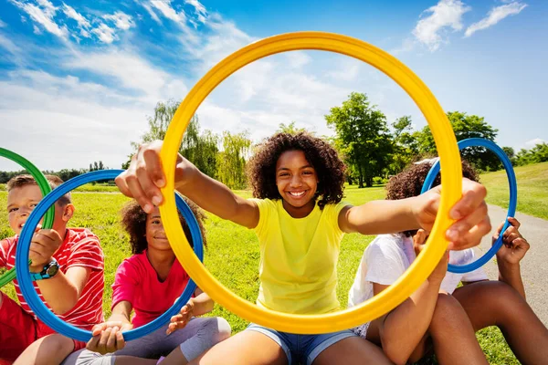 Grupo Crianças Com Menina Olhando Através Aro Colorido Parque Sorrindo — Fotografia de Stock