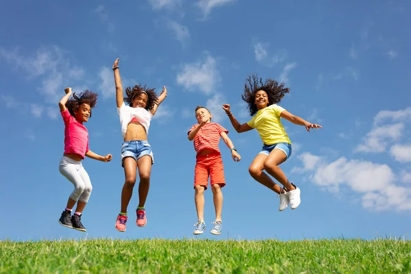 Group Children Boys Girls Jump Blue Sky Clouds Grass Field — Stock Photo, Image