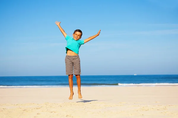 Photo Happy Little Handsome Boy Jump High White Sand Beach — Zdjęcie stockowe