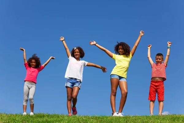 Group Happy Kids Lifted Hands Stand Lawn Park Clean Sky — Stock Photo, Image