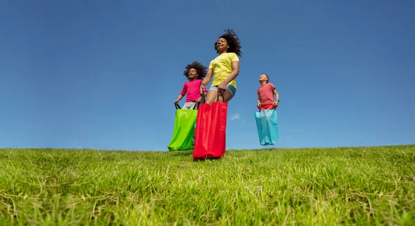 Group Kids Play Gunny Race Competitive Game Field Hop Forward — Stock Photo, Image