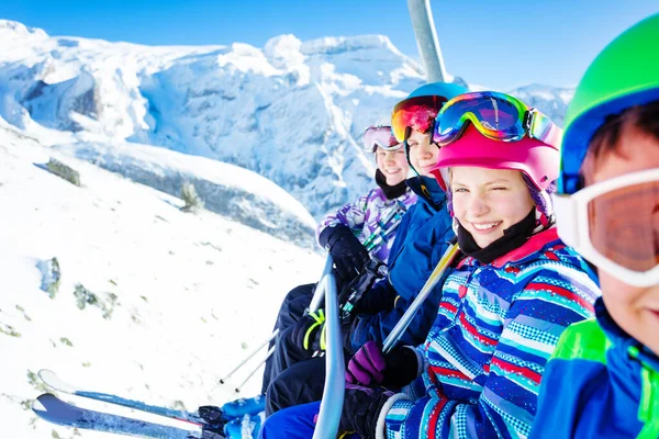 Happy Smiling Group Children Sit Chairlift Looking Camera Sunny Mountain — Stock Photo, Image