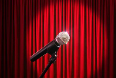 Kırmızı perde çerçevede bir sahnede mikrofon
