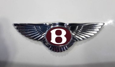 Kuala Lumpur, Malaysia-December 1,2018 :  Bently logo on white car body. Bentley Motors Limited  is a British manufacturer of luxury cars, based in Crewe, England. clipart