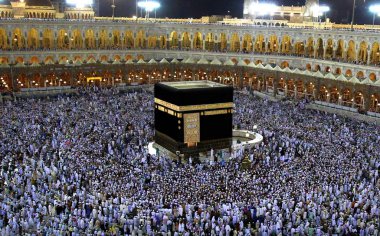 MAKKAH, SAUDI ARABIA - FEBRUARY 10, 2017:Muslim pilgrims from all over the world gathered to perform Umrah at the Al- Haram Mosque in Mecca. A crowd of pilgrims circumabulate (tawaf) Kaaba. clipart