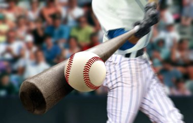 Baseball player hitting ball with bat in close up clipart