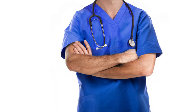 Doctor in medical scrubs standing with arms crossed isolated on white