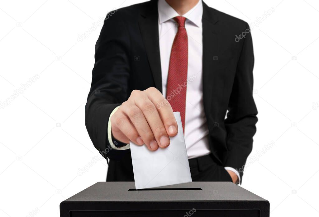 Man casting his vote into ballot box in close up over white background