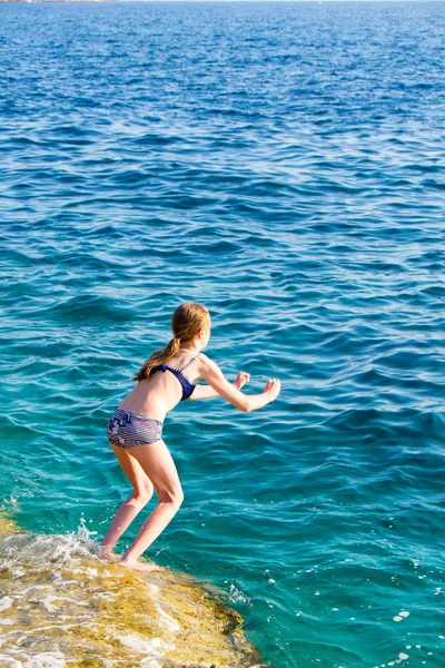 Genç kız denize zıplıyor