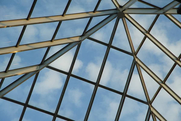 Glass roof and the view of the steel frame and the blue sky which cleared up