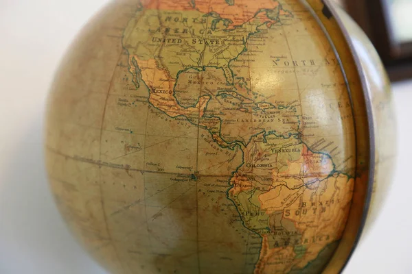 Old brown terrestrial globe with a view of the America Continent