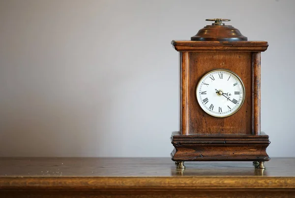 Table clock of the old wooden frame of the room