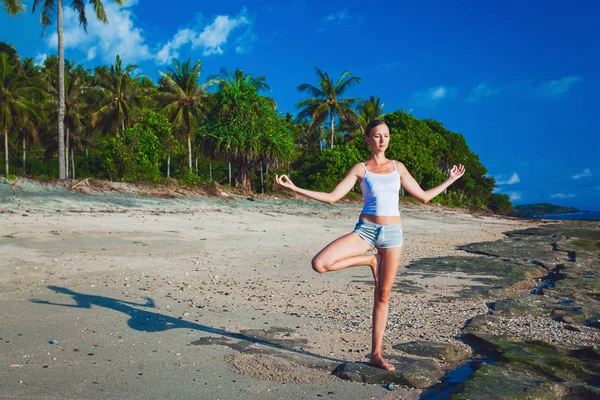 Beautiful young woman doing yoga exercise Stock Photo