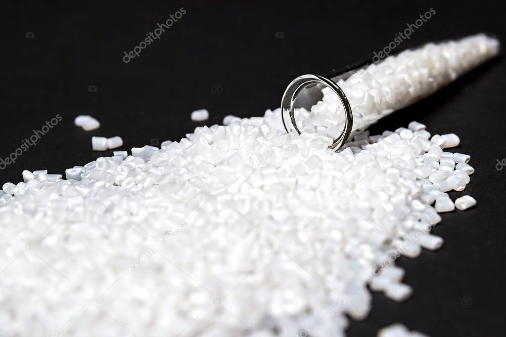 Plastic in granules. Polymer pellets. Isolated on a black background.