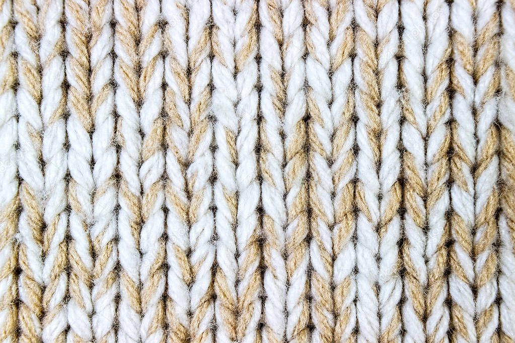 Knitted background. Knitted texture. A sample of knitting from wool. Knitting Pattern.