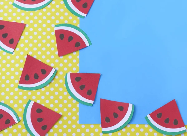 Watermelon slices Paper cut on yellow polka dot background with mockup of blue paper card. Summer concept with text space for banner or poster. Paper craft. Flat lay.