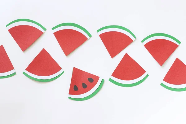 Minimalist summer concept with slices of watermelon without seeds on white  background. Summer shopping and ecology concept with text space for your design. Paper cut. Flat lay.