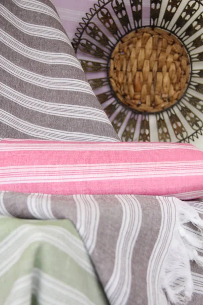 Cotton towels of colored stripes and a decorative metal tray