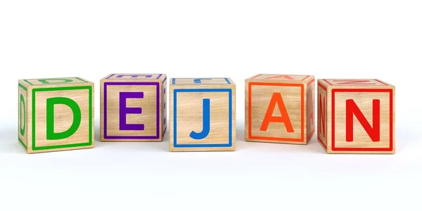 Cubos de brinquedo de madeira isolados com letras com nome dejan — Fotografia de Stock