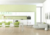 Zelená moderní kuchyň v pokoji s kamennou zdí