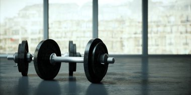 Bir spor salonu zemin üzerinde siyah plakalı halter