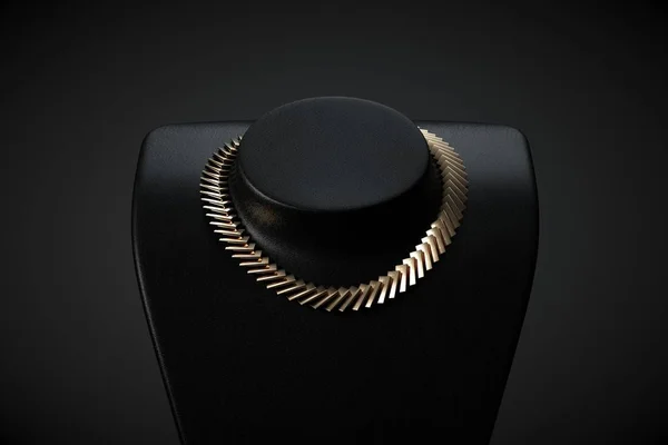 Golden necklace on black studio background — Stock Photo, Image