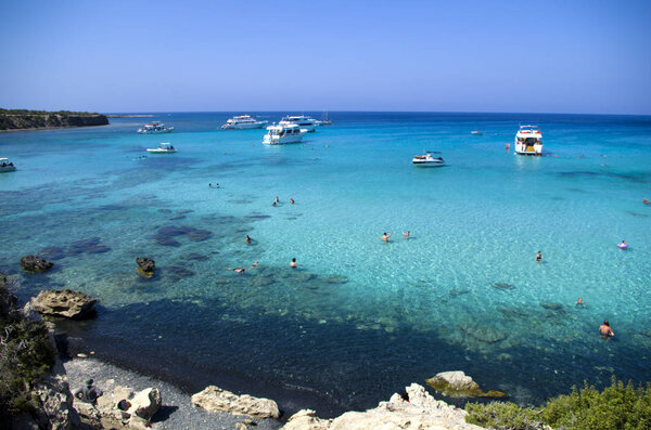 The Blue Lagoon with the people and boats at the summer sunny day, concept of a vacation