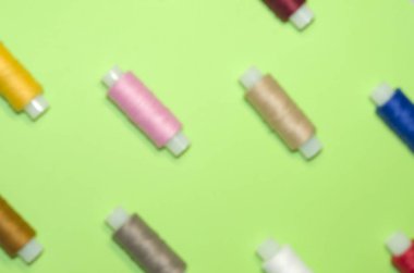 iğne, zanaat, dikiş ve terzilik konsepti - yeşil arka plan üzerinde renkli iplik makaraları satır, düz yatıyordu, üst görünümü