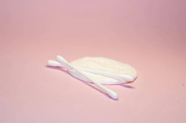 Facial concept. Cotton pads.Cotton Cosmetic Makeup Removers Tampons. Means of personal hygiene. Pink background.