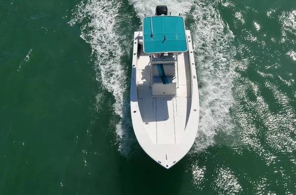 Overhead view of a sports fishing boat powered by a single outboard engine.