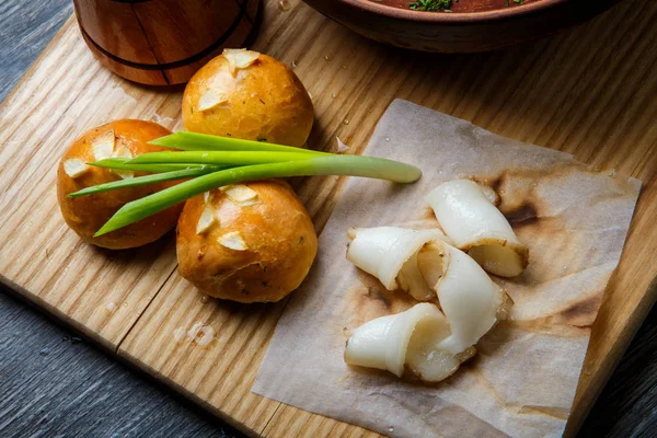Traditional ukrainian baked doughnut with garlic topping decorated with green onion and sliced tallow on wooden plate — Stock Image Traditional Ukrainian Baked Doughnut Garlic Topping Decorated Green Onion Sliced Royalty Free Stock Photos