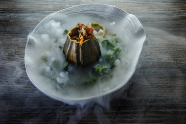 üstten görünüm üzerinde tatlı taze nane ve ahşap masa arka plan üzerinde restoran plaka üzerinde duman süslenmiş kabak servis