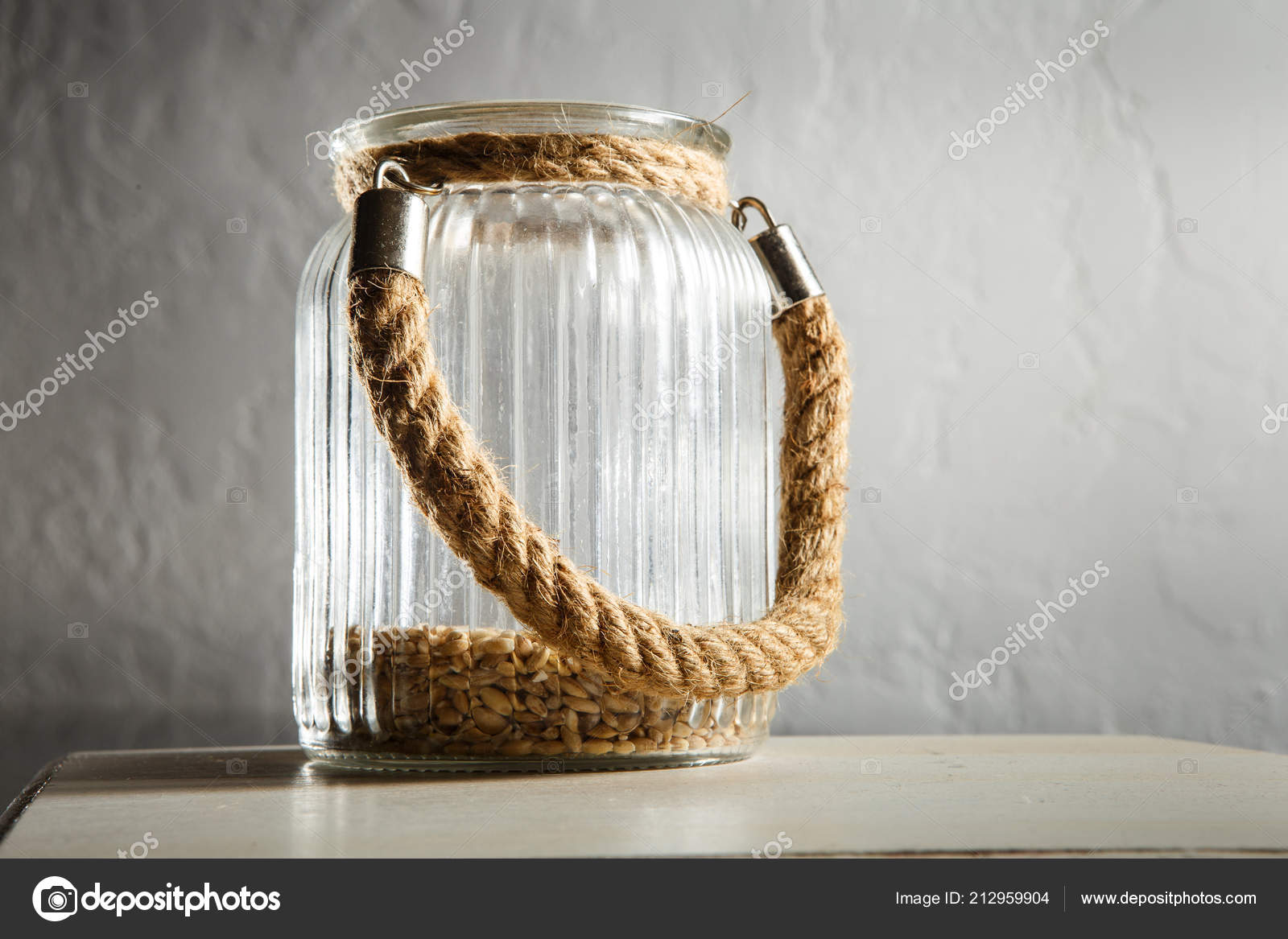 Wheat Seeds Open Glass Jar Rope Handle Stand Grey Table Stock Photo by