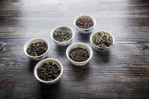 Assorted Tea Leaves Six White Small Vessels Gray Wooden Table — Stock Photo, Image