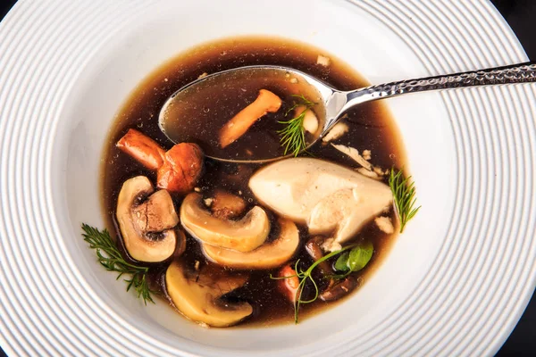 Top view closeup vegetarian soup with mushrooms, mozzarella cheese, and dill served in restaurant white plate and spoon — Stock Image Top View Closeup Vegetarian Soup Mushrooms Mozzarella Cheese Dill Served Stock Picture