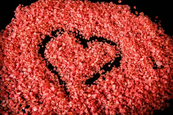 macro big heart painted on pink organic sea salt