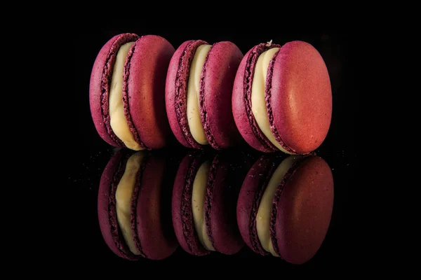 Closeup three berry macaroons with yellow filling — Stock Photo, Image