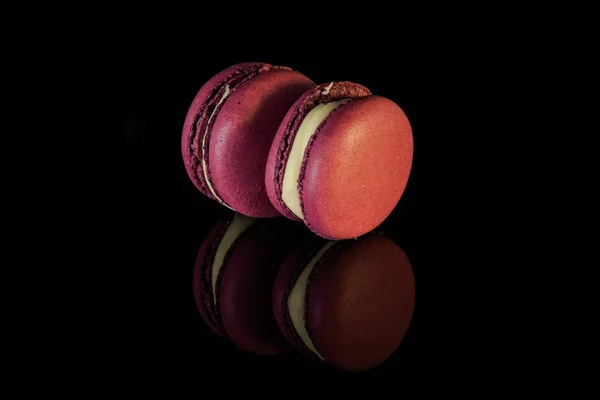 Two purple berry macarons with yellow filling — Stock Photo, Image