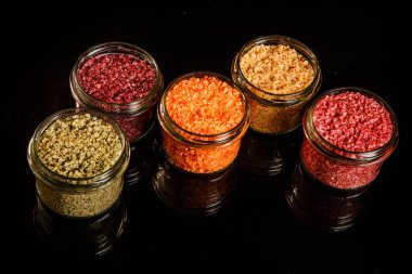 farklı renklerde deniz tuzu ile dolu küçük cam kavanoz