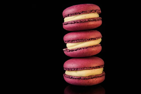 Tower of three purple macaroons with yellow filling — Stock Photo, Image