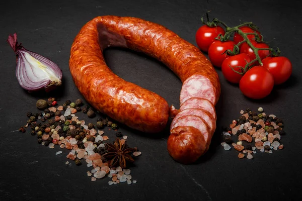 sliced circle of smoked sausage with onion and tomatoes cherry