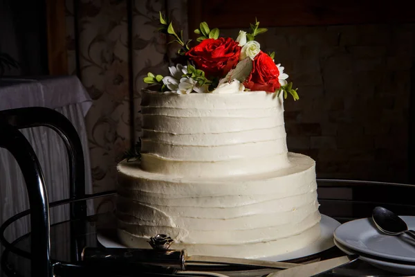 Étvágygerjesztő kétszintű esküvői torta díszített vörös rózsa — Stock Fotó