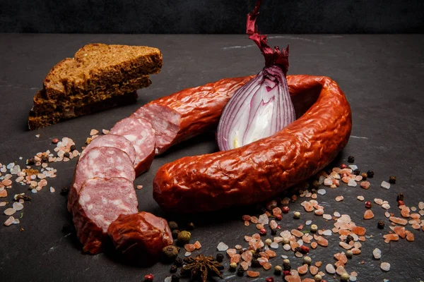 delicatessen dry cured sausage with onion and rye bread slices