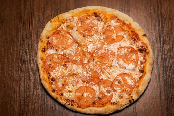 top view of whole round sliced tasty italian pizza margherita