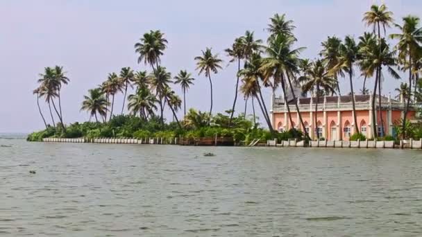 Camera Passes by Pink House on River Bank in Tropics — Stock Video