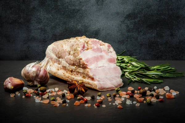Chunk of salted meat lard with pink salt, spices, garlic, and rosemary — Stock Image Chunk of salted meat lard with pink salt, spices, garlic, and rosemary Stock Picture