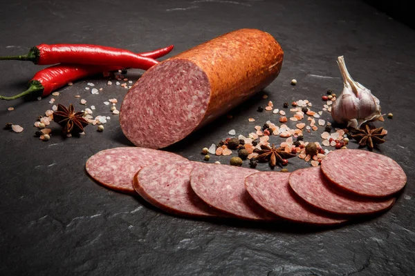 Small chunk of smoked cervelat salami sausage with garlic and chili — Stock Photo, Image