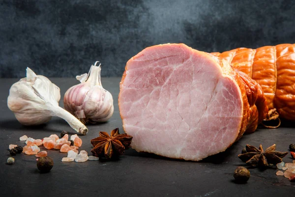 Closeup halfs of smoked gammon with salt, spices and two garlic — Stock Image Closeup halfs of smoked gammon with salt, spices and two garlic Stock Photo