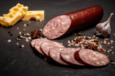 appetizing sliced cheddar summer sausage with cheese and garlic clipart