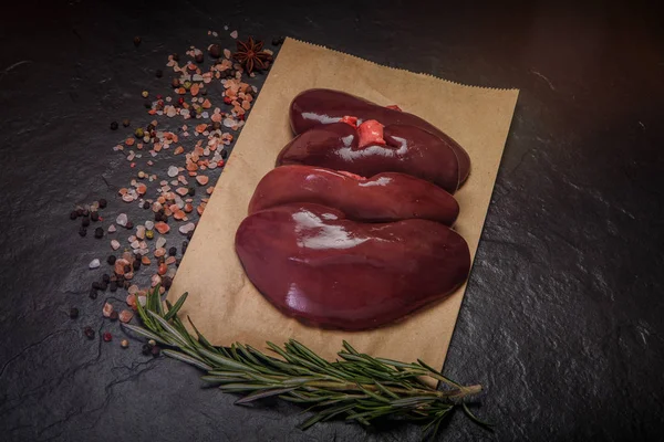 Top view on group of raw pork kidneys with rosemary — Stock Image Top view on group of raw pork kidneys with rosemary Royalty Free Stock Photos